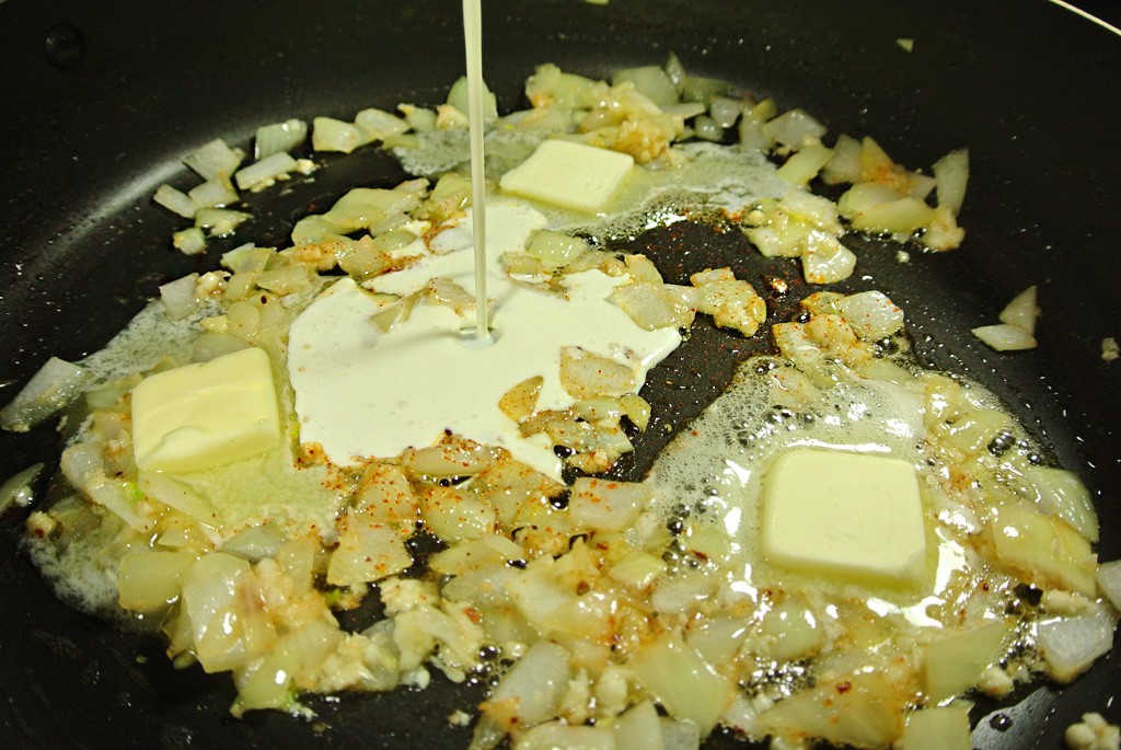 Add the cream, butter and parmesan to the garlic and onions