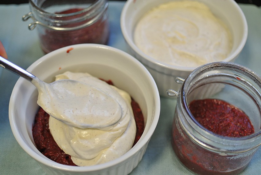 Spoon cheesecake layer onto red velvet